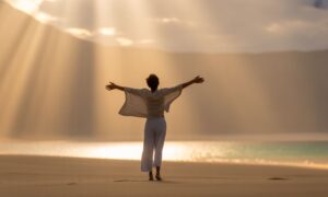 Golden sunrise over the ocean with glowing light rays symbolizing a powerful spiritual awakening