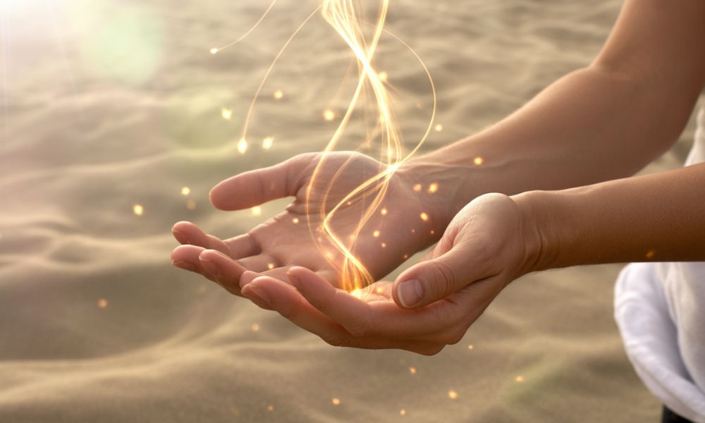 Hands releasing golden energy symbolizing emotional healing and spiritual peace
